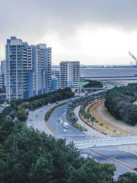 Vehicles on road along built structures