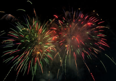 Low angle view of firework display at night