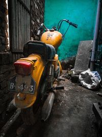 Abandoned vintage car against buildings in city