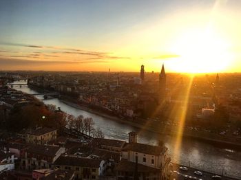 High angle view of city lit up at sunset