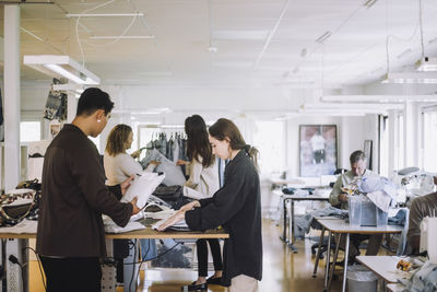 Multiracial male and female design professionals working together at workshop