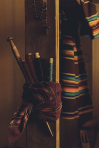 Thread spools and hand tools on wooden column