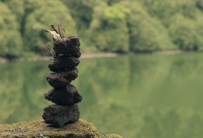 Close-up of stack of rock in lake