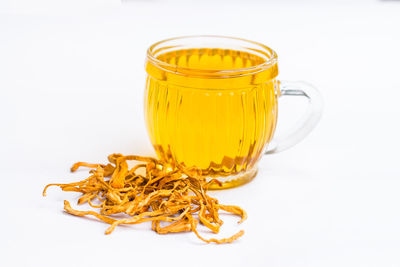 Close-up of glass of jar against white background
