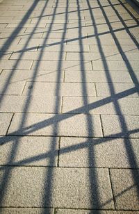 High angle view of shadow on tiled floor