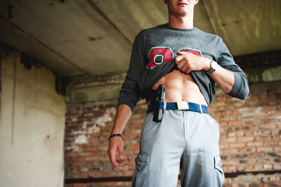 Midsection of man with handgun