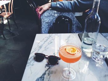 Midsection of woman sitting on table