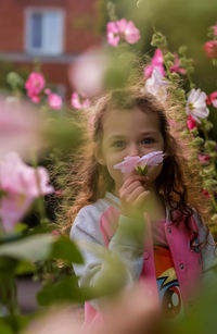 Portrait of cute girl with pink flowers