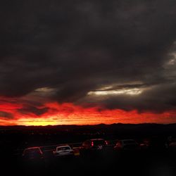 Storm clouds over landscape during sunset