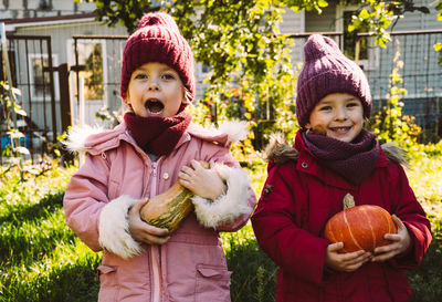 Funny kids outdoors with pumpkins. happy childhood in the village, harvesting for the holidays