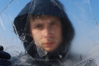 Close-up of man seen through ice