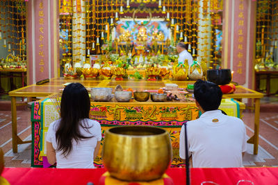 Rear view of man and woman in temple