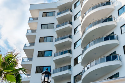 Low angle view of an apartment building with balconies. residential real estate.