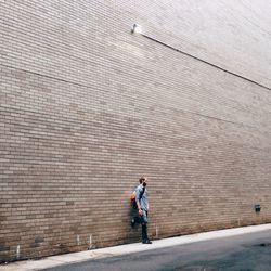 Full length of woman standing by railing
