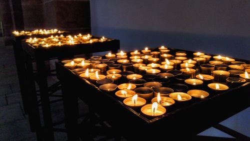 Illuminated candles on table