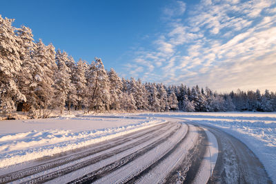 Scenic view of snow covered land against sky