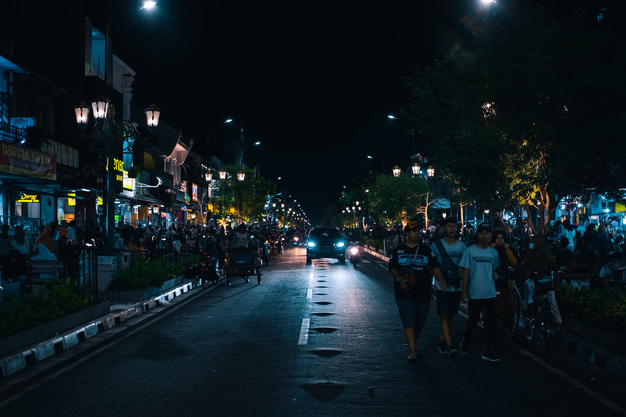 PEOPLE ON ROAD AT NIGHT