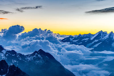 Scenic view of snow mountains against sky during sunset