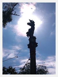 Low angle view of statue against cloudy sky