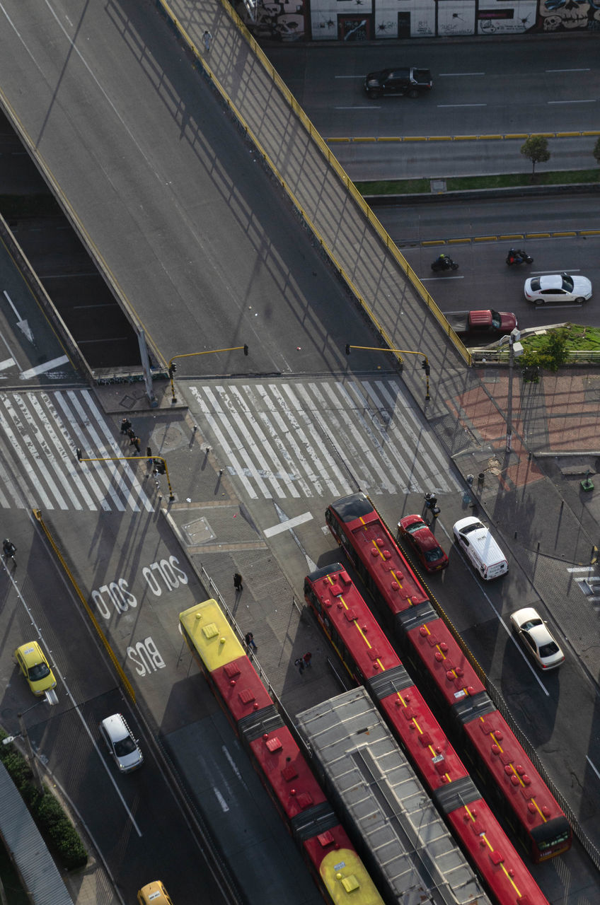 transportation, mode of transportation, high angle view, transport, architecture, road, motor vehicle, land vehicle, city, car, street, no people, vehicle, public transport, rail transportation, public transportation, traffic, built structure, sign, road marking, urban area, track, day, stadium, railroad track, outdoors, city street, aerial view, marking, sport venue, industry, lane, travel, freight transportation, train, building exterior, business