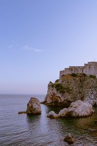 Scenic view of sea and rocks against sky