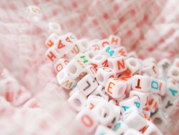 Close-up of toy blocks with colorful alphabets on fabric