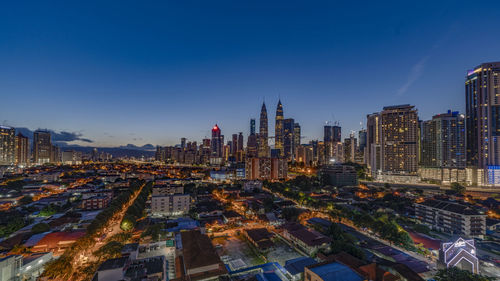 High angle view of city lit up at night