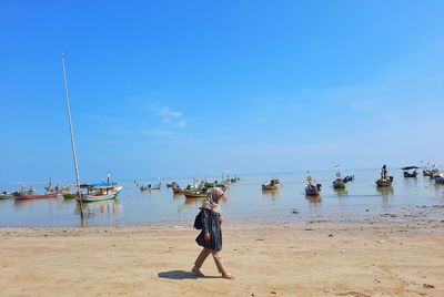 Woman on beach against sky