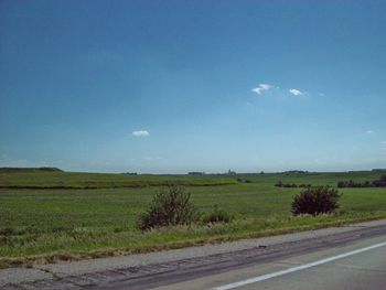 Scenic view of field against blue sky