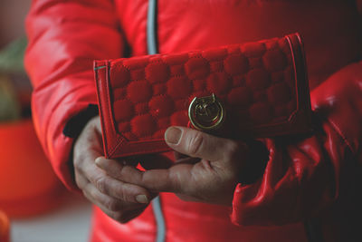 Cropped image of woman holding red purse