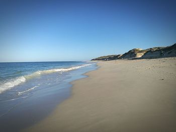 View of beach against clear sky