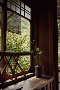 Vase of flowers against a wooden window ledge in traditional japanese room.  kyoto, japan