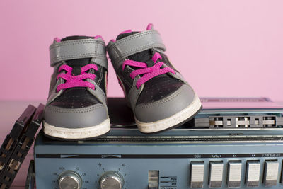 Close-up of gray shoes on radio