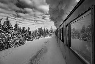 Snow covered train against sky during winter