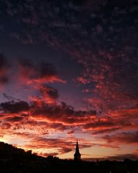 Silhouette of built structure against dramatic sky