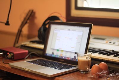 Laptop and breakfast on desk at home