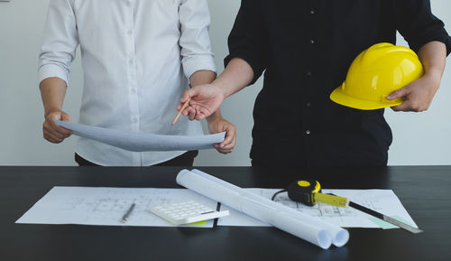 Midsection of business colleagues working at office