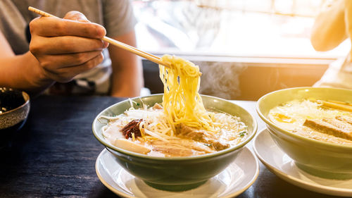 Close-up of hand holding food on table