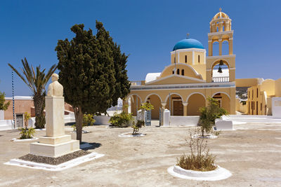 Church by building against sky