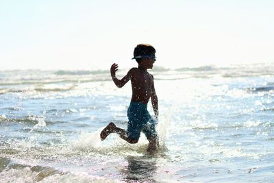 Woman jumping in sea