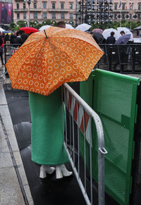 Rear view of woman holding umbrella