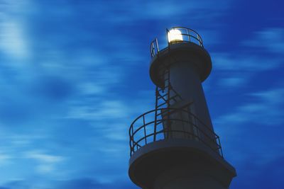 Low angle view of tower against cloudy sky