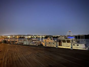 Illuminated buildings against clear sky at night