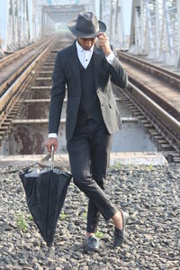 Full length of man walking on railroad track