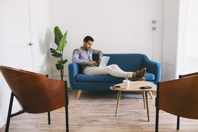 Woman sitting on chair at home