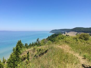 Scenic view of sea against clear blue sky