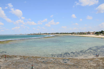 View of beach against cloudy sky