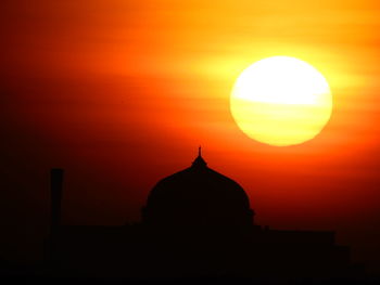 Silhouette temple against sky during sunset