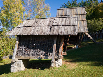 Old abandoned house on field against sky