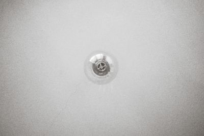 Low angle view of light bulb hanging from ceiling